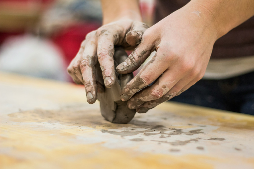 A person modelling with clay