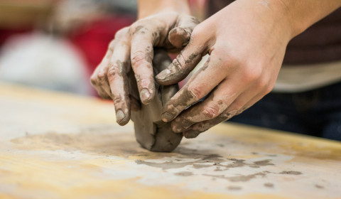 A person modelling with clay