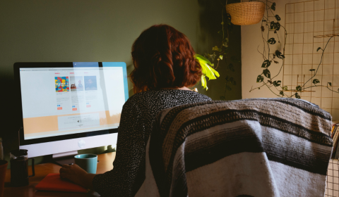 Photograph of a woman working in her home office