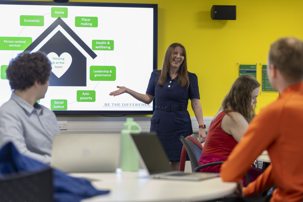 Image of event speaker delivering presentation to attendees
