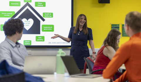 Image of event speaker delivering presentation to attendees