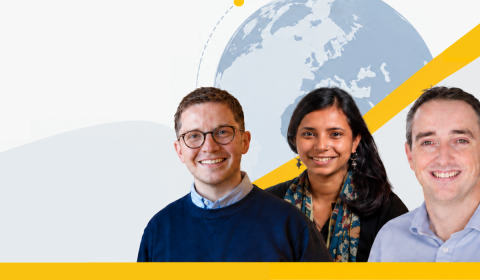 Three smiling people standing in front of a globe graphic with yellow diagonal accents.