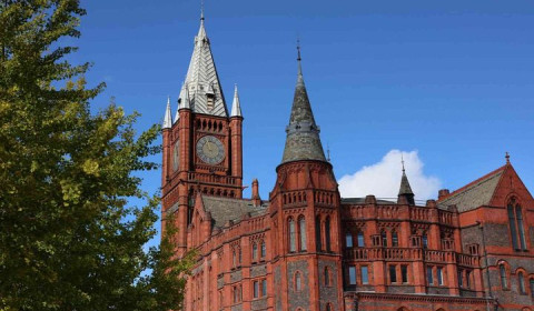 The redbrick Victoria Gallery & Museum (VGM), with spire and clock tower, and a tree on the left