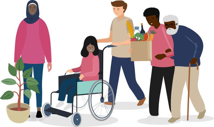 An image of 5 people of different ages and ethnicities, walking together. There is a young person pushing someone else in a wheelchair, showing visibly what it means to be a young carer.